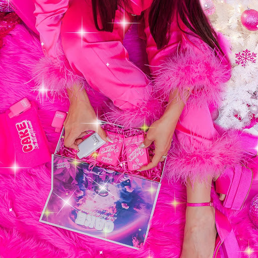 A display of a woman in pink pajamas holding a box of Cake vapes with different terpenes flavours. 